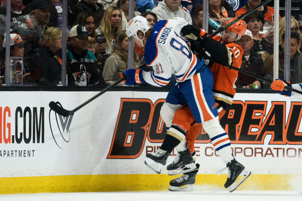 Edmonton Oilers center Josh Samanski, left, hits Anaheim Ducks left wing Chris Kreider during the second period of Game 4 in the first round of an NHL hockey Stanley Cup playoff series Sunday, April 26, 2026, in Anaheim, Calif. (AP Photo/Kyusung Gong)