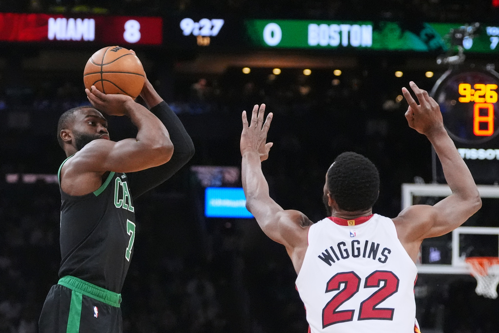 Boston Celtics guard Jaylen Brown (7) looks to shoot over Miami Heat forward Andrew Wiggins (22) during the first half of an NBA basketball game, Friday, Feb. 6, 2026, in Boston. (AP Photo/Charles Krupa)