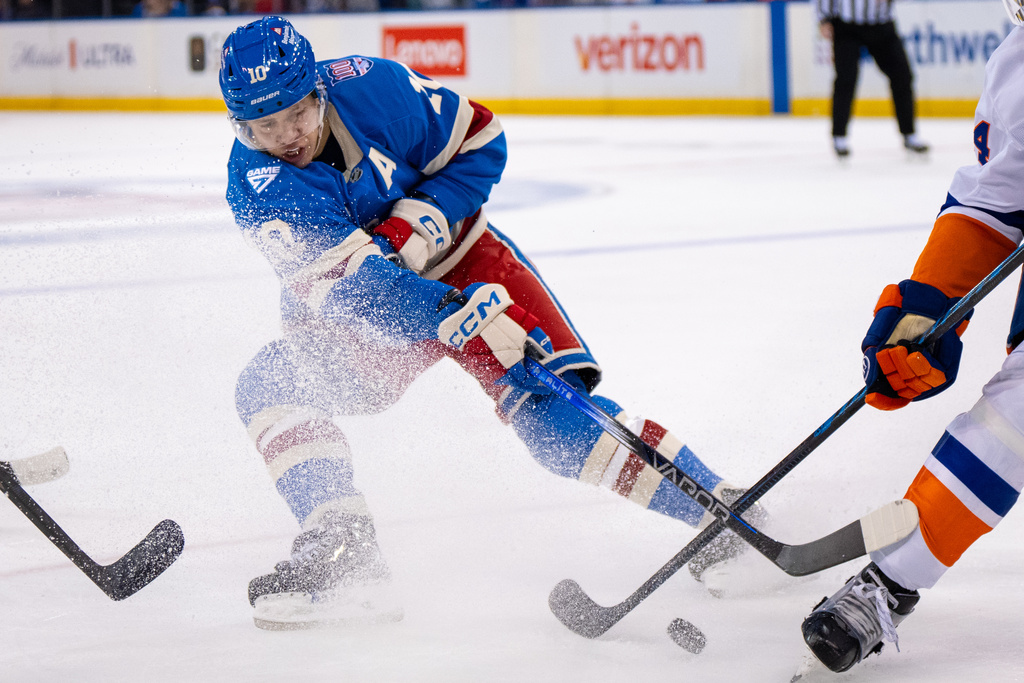 New York Rangers left wing Artemi Panarin passes the puck during the second period of an NHL hockey game against the New York Islanders, Saturday, Nov. 8, 2025, in New York. (AP Photo/Angelina Katsanis)