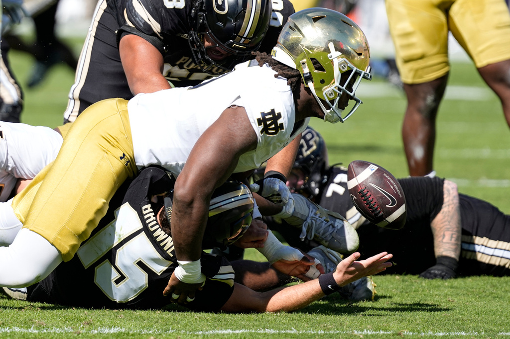 Notre Dame defensive lineman Boubacar Traore (5) sacks and forces a fumble by Purdue quarterback Ryan Browne (15) during the first half of an NCAA college football game in West Lafayette, Ind., Saturday, Sept. 26, 2026. (AP Photo/Michael Conroy)