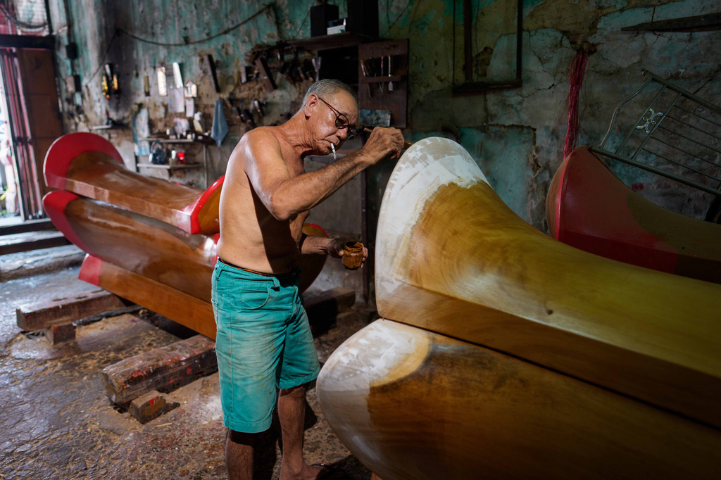 Goh Khuay Par applies a coat of finish to a Mei Hua coffin at his family's workshop in Muar, Malaysia, Monday, Sept. 7, 2026. (AP Photo/Vincent Thian)