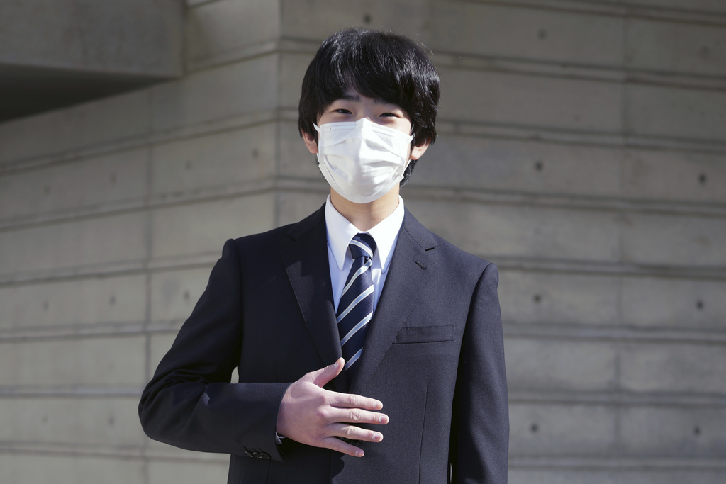 FILE- Japan's Prince Hisahito gestures as he poses for a photo before his entrance ceremony of Senior High School at Otsuka, the University of Tsukuba, Saturday, April 9, 2022, in Tokyo. (AP Photo/Eugene Hoshiko, Pool)