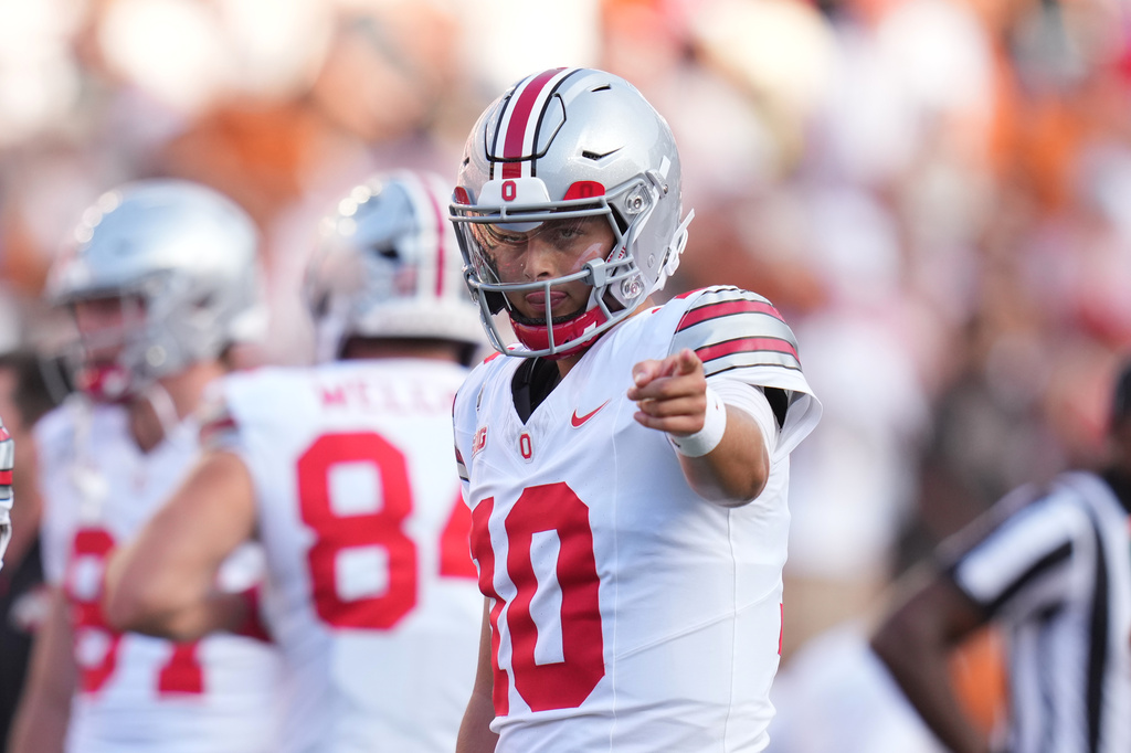 Ohio State quarterback Julian Sayin (10) warms hip before an NCAA college football game against Texas in Austin, Texas, Saturday, Sept. 12, 2026. (AP Photo/Eric Gay)