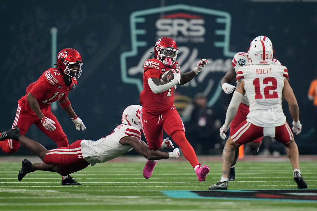 Utah running back Wayshawn Parker (1) runs for a gain against Nebraska during the first half of the Las Vegas Bowl NCAA college football game Wednesday, Dec. 31, 2025, in Las Vegas. (AP Photo/John Locher)