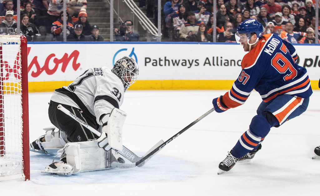 Los Angeles Kings goalie Anton Forsberg (31) makes the save on Edmonton Oilers' Connor McDavid (97) during an overtime of an NHL hockey game in Edmonton on Saturday, Jan. 10, 2026. (Jason Franson/The Canadian Press via AP)