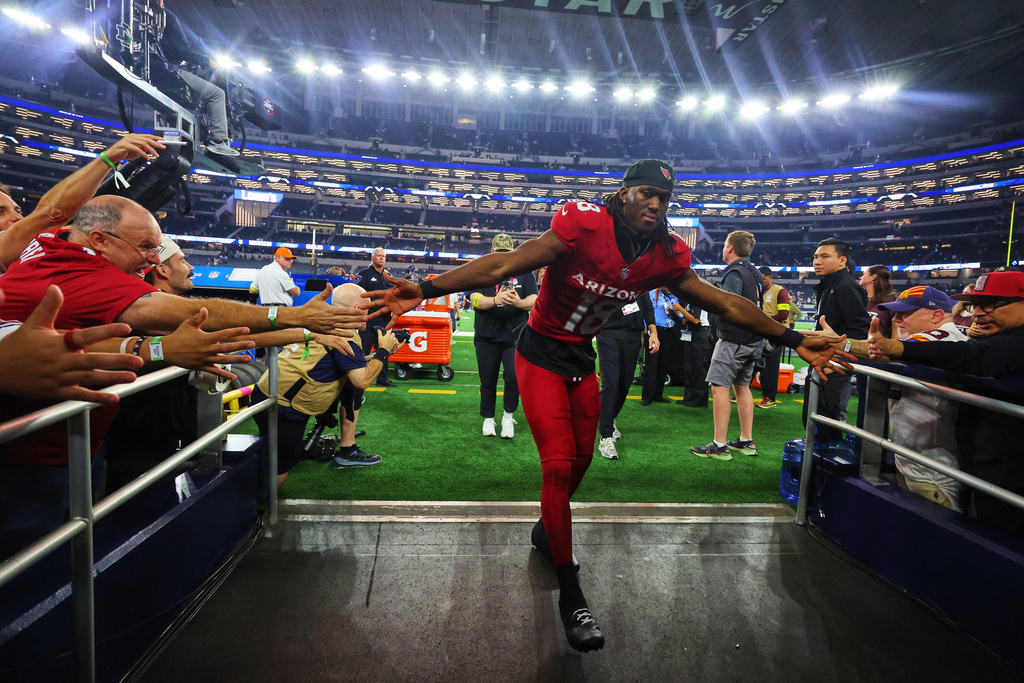 Arizona Cardinals' Marvin Harrison Jr. greets fans as he walks off the field after an NFL football game against the Dallas Cowboys Monday, Nov. 3, 2025, in Arlington, Texas. (AP Photo/Richard Rodriguez)