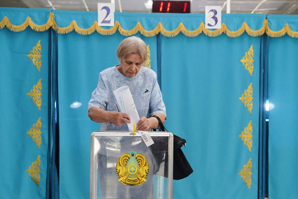A woman casts her ballot at a polling station during early parliamentary elections in Almaty, Kazakhstan, Sunday, Aug. 23, 2026. (AP Photo/Vladimir Tretyakov)