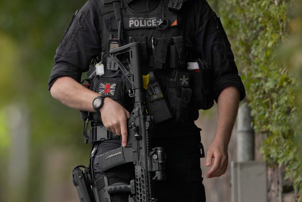 An armed police officer patrols near the scene of a stabbing incident at Heaton Park Hebrew Congregation synagogue, in Crumpsall, Manchester, England, Thursday, Oct. 2, 2025. (AP Photo/Ian Hodgson)