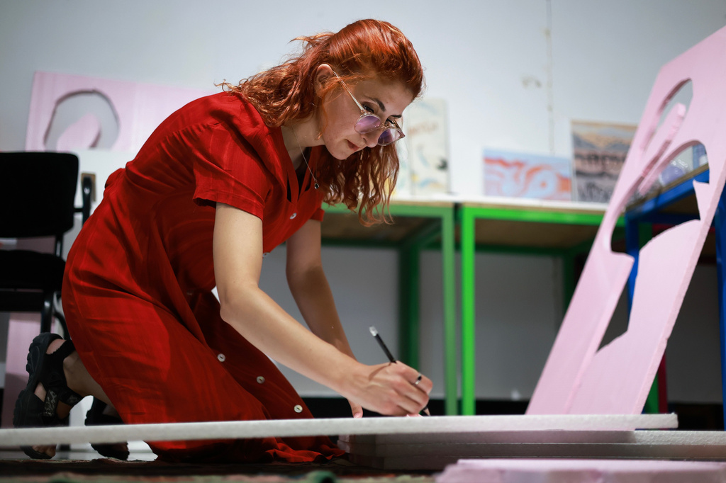 Designer Fatma Paja handcrafts foam flamingos in order to be used at protests against a coastal development project in western Albania linked to Jared Kushner, son-in-law of President Donald Trump, in Tirana, Albania, Friday, June 26, 2026. (AP Photo/Hameraldi Agolli)