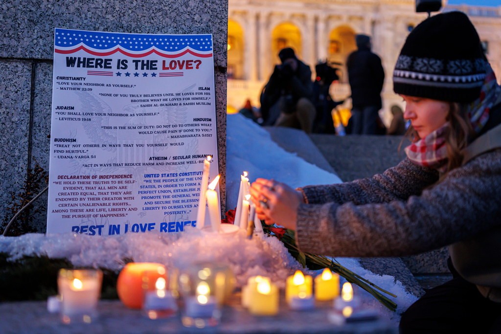 Candles burn around a poem written by Renee Good during a vigil honoring her on Friday, Jan. 9, 2026, in St. Paul, Minn., outside the Minnesota State Capitol. (Kerem Yücel/Minnesota Public Radio via AP)