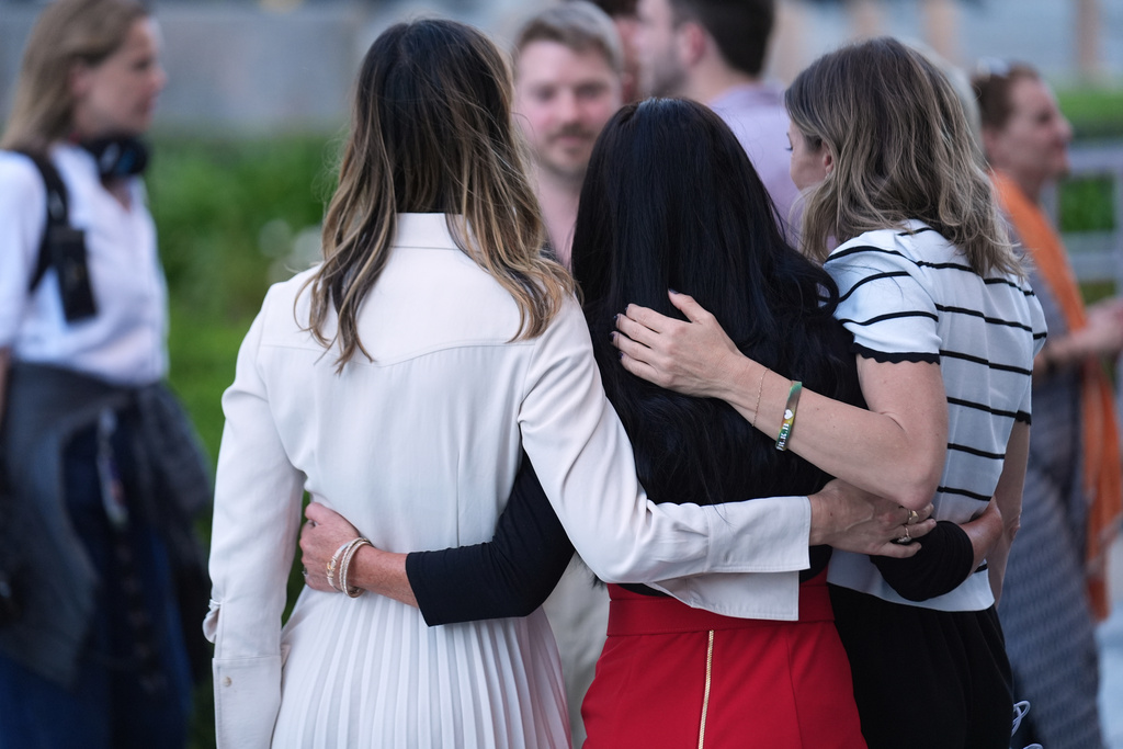 Parents of children who they say were victims of social media platforms hug outside Los Superior Courthouse after to listening to closing arguments Thursday, March 12, 2026. (AP Photo/Damian Dovarganes) ADDITION: to clarify opinion.