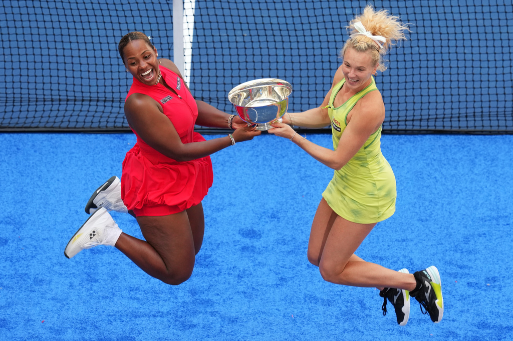 Taylor Townsend, of the United States, left, and Katerina Siniakova, of the Czech Republic, right, jump with their trophy after winning the women's doubles final of the U.S. Open tennis championships against Ashlyn Krueger, of the United States, and Robin Montgomery, of the United States, Friday, Sept. 11, 2026, in New York. (AP Photo/Kirsty Wigglesworth)