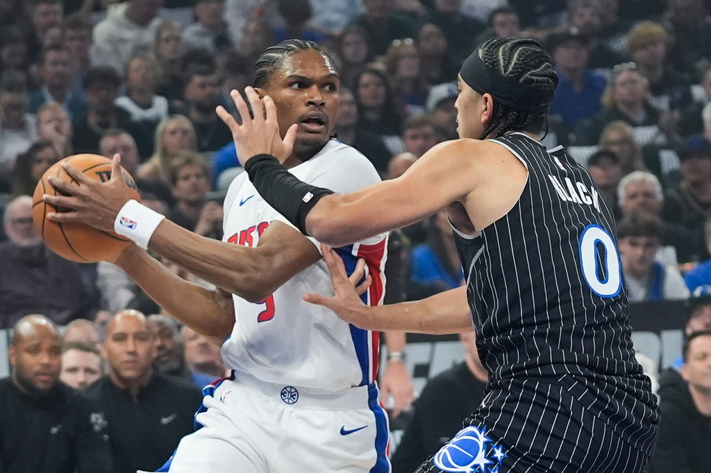 Detroit Pistons guard Ausar Thompson, left, looks to pass the ball as Orlando Magic guard Anthony Black (0) defends during the first half in Game 6 of a first-round NBA basketball playoffs series, Friday, May 1, 2026, in Orlando, Fla. (AP Photo/John Raoux)