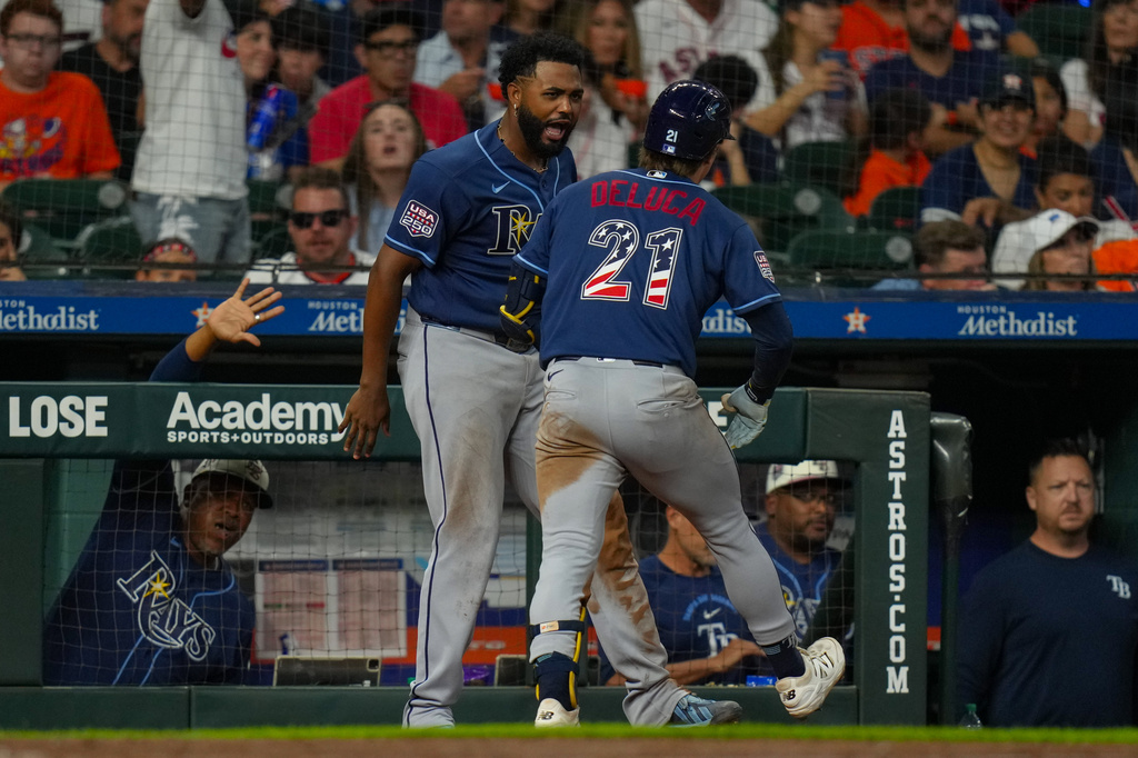 Tampa Bay Rays' Jonny DeLuca (21) celebrates with Junior Caminero, center left, after hitting a home run during the seventh inning of a baseball game against the Houston Astros in Houston, Saturday, July 4, 2026. (AP Photo/Jon Shapley)