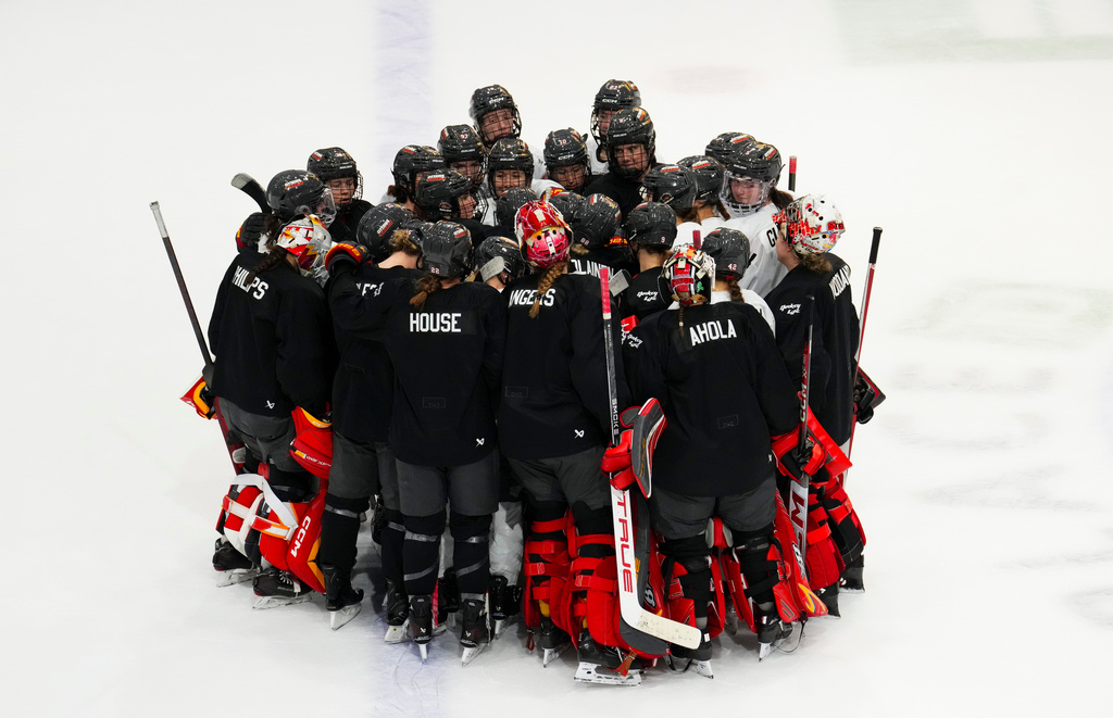 Ottawa Charge players huddle at the end of an on-ice session during PWHL hockey training camp, Wednesday, Nov. 12, 2025, in Ottawa, Ontario (Sean Kilpatrick/The Canadian Press via AP)