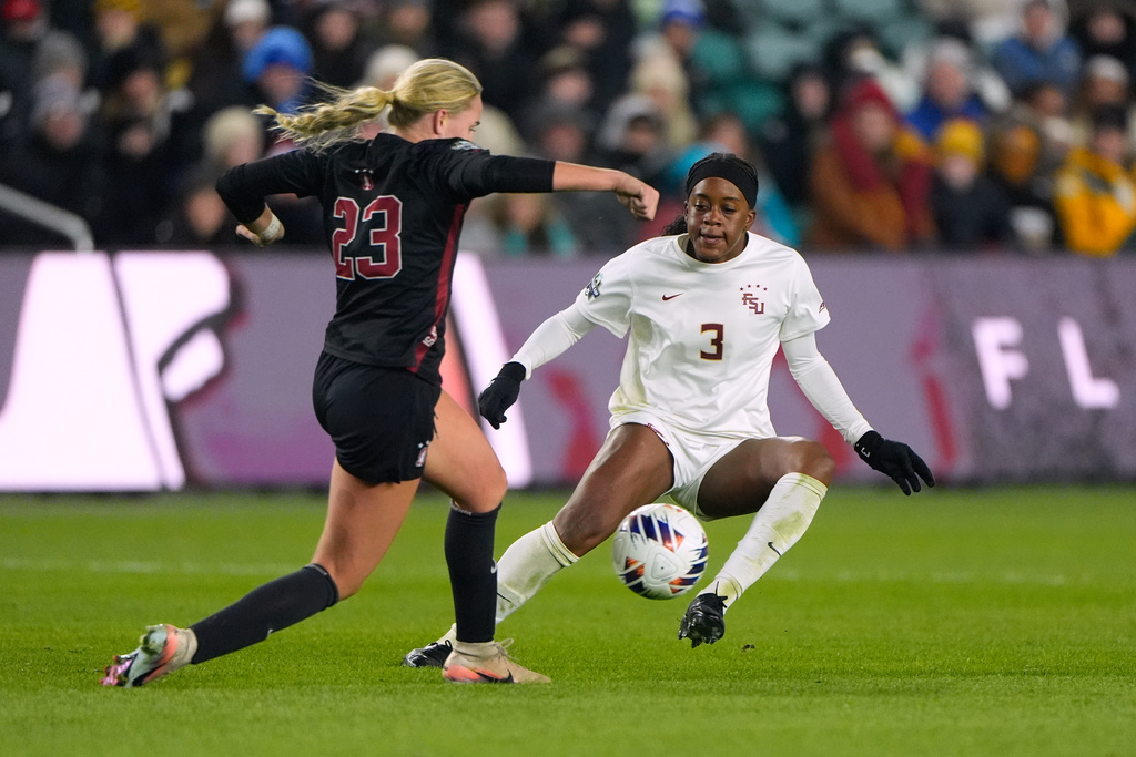 Stanford's Lily Freer (23) and Florida State's Jaida McGrew (3) battle for the ball during the second half of the NCAA college soccer tournament final Monday, Dec. 8, 2025, in Kansas City, Mo. (AP Photo/Charlie Riedel)