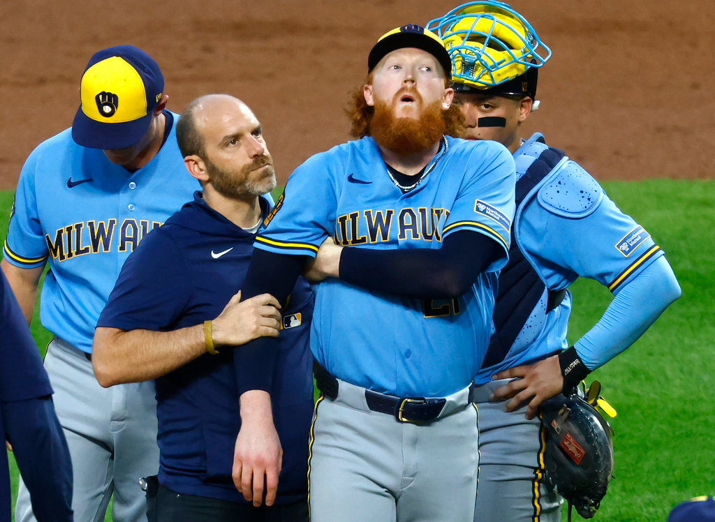 Milwaukee Brewers pitcher Dustin May reacts after being hit by a batted ball during the first inning of a baseball game against the New York Mets, Wednesday, Aug. 26, 2026, in New York. (AP Photo/Noah K. Murray)