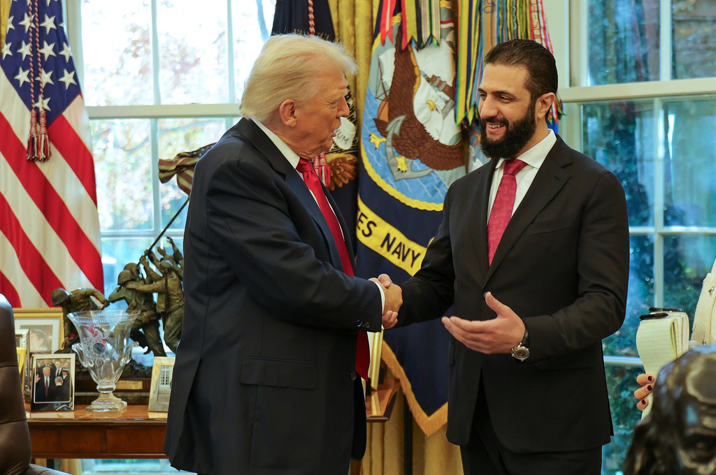 FILE - In this photo released by Syrian Presidency press office, President Donald Trump, left, shakes hands with Syria's President Ahmad al-Sharaa, at the White House in Washington, Monday, Nov. 10, 2025. (Syrian Presidency press office via AP, File)