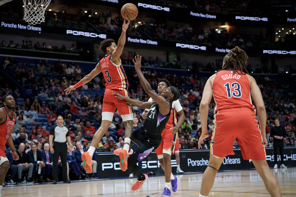 New Orleans Pelicans guard Jordan Poole (3) blocks the shot of Utah Jazz guard Bez Mbeng (21) during the first half of an NBA basketball game in New Orleans, Tuesday, April 7, 2026. (AP Photo/Matthew Hinton)