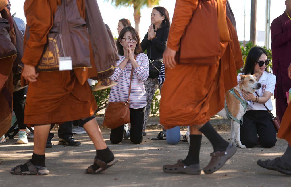 People watch as the Buddhist monks from the Huong Dao Vipassana Bhavana Center in Fort Worth, who are undertaking a 2,300 mile pilgrimage of "Walk for Peace," arrive for a welcome ceremony at Hong Kong City Mall in Houston, Friday, Nov. 14, 2025. (Melissa Phillip/Houston Chronicle via AP)