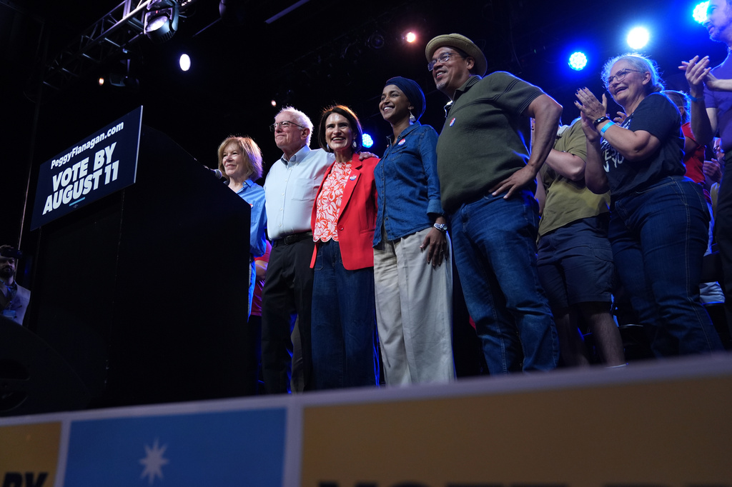 Minnesota Lt. Gov. Peggy Flanagan, center, a Democratic candidate for U.S. Senate, poses with politicians including Sen. Bernie Sanders, I-Vt., second from left, during a campaign rally Monday, July 20, 2026, in Minneapolis. (AP Photo/Ellen Schmidt)