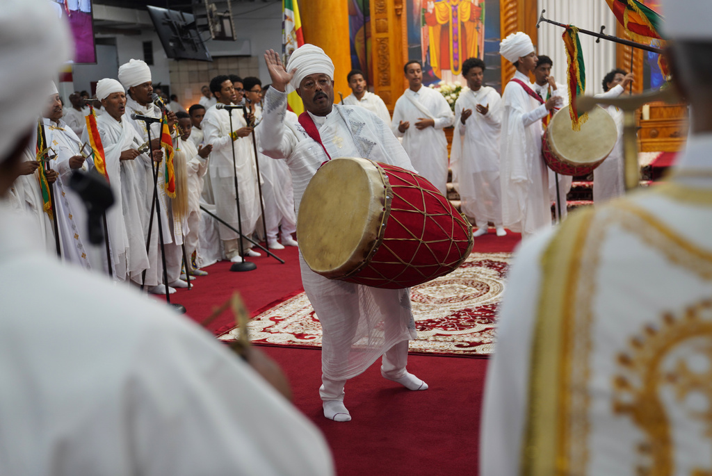 Deacon Tassew Yinadu, center plays the drum, or kebero, during Easter service at Re'ese Adbarat Debre Selam Kidist Mariam Church, an Ethiopian Orthodox Tewahedo church, in Washington, Saturday, April 11, 2026. (AP Photo/Jessie Wardarski)