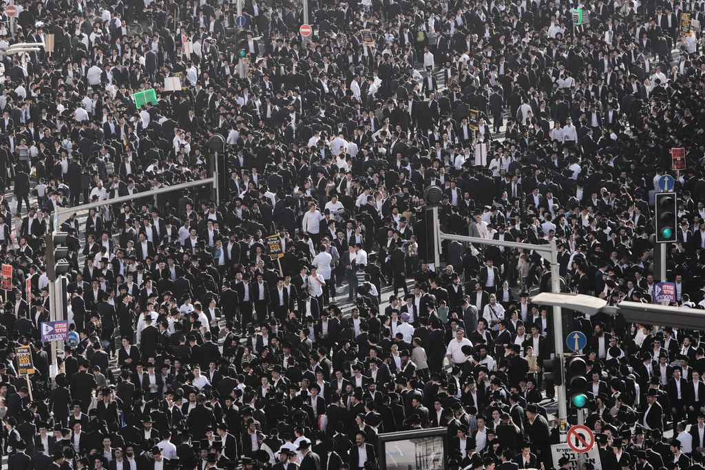 Ultra-Orthodox Jewish men attend a rally against plans to force them to serve in the Israeli military, in Jerusalem, Thursday, Oct. 30, 2025. (AP Photo/Mahmoud Illean)