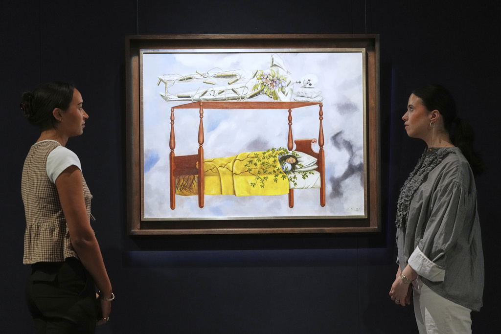 A painting by Frida Kahlo called El sueño (La cama) is displayed at Sotheby's auction rooms, the painting estimated at 40-60 million US dollars is part of a collection of surrealist masterpieces unveiled in London ahead of their sale in New York, Friday, Sept. 19, 2025. (AP Photo/Kirsty Wigglesworth)
