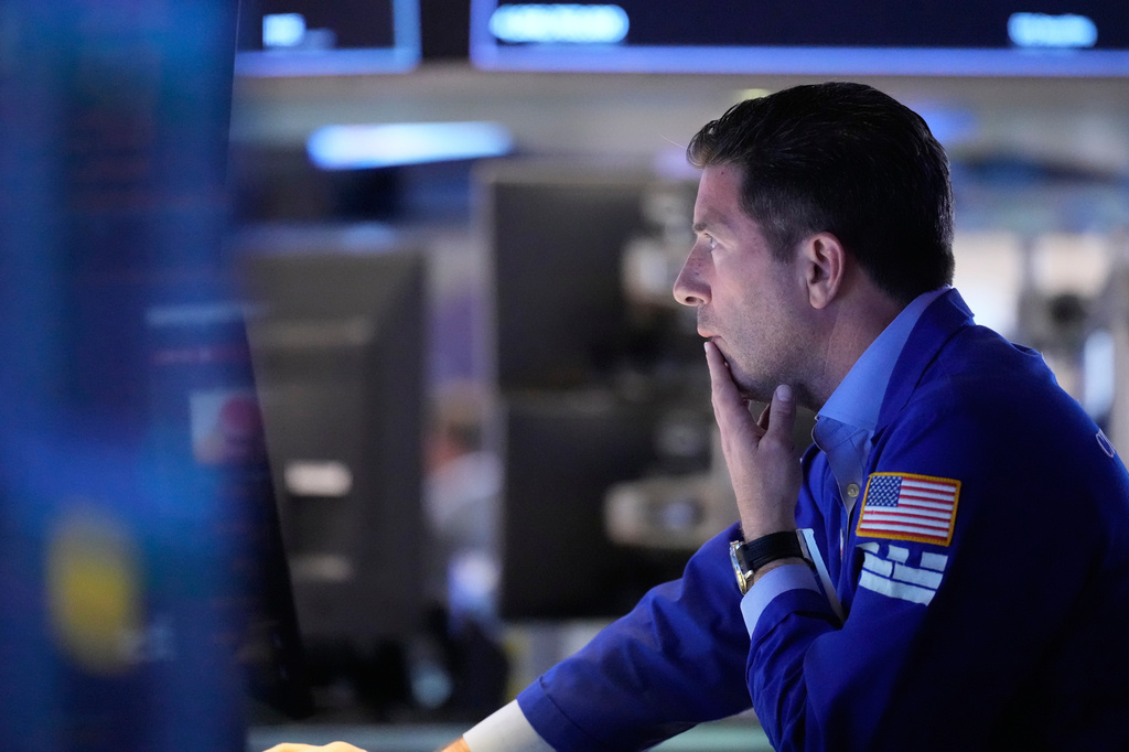 People work on the floor at the New York Stock Exchange in New York, Monday, April 13, 2026. (AP Photo/Seth Wenig)