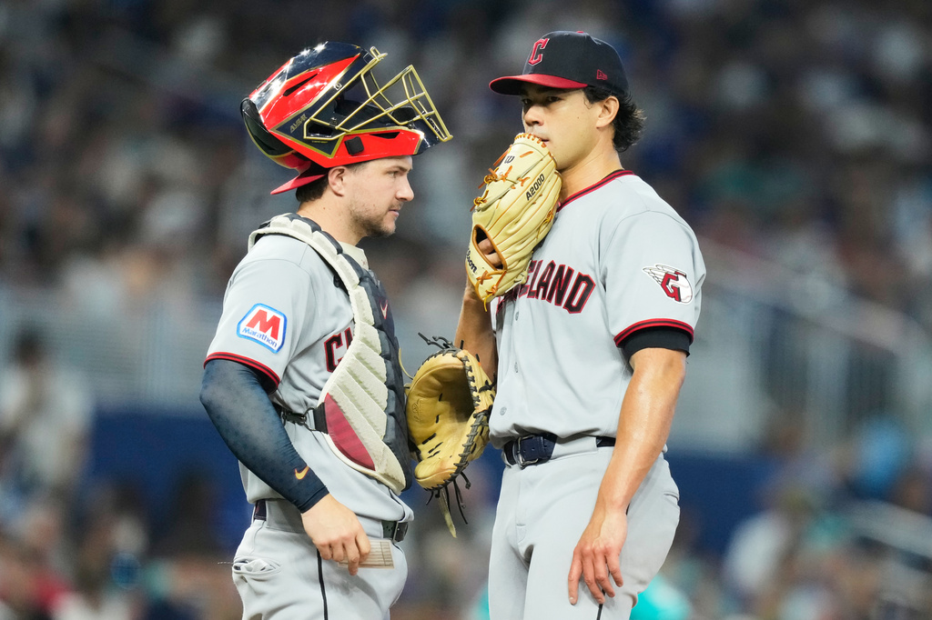 Cleveland Guardians catcher Patrick Bailey, left, talk with starting pitcher Joey Cantillo, right, during the third inning of a baseball game against the Miami Marlins, Sunday, July 12, 2026, in Miami. (AP Photo/Lynne Sladky)