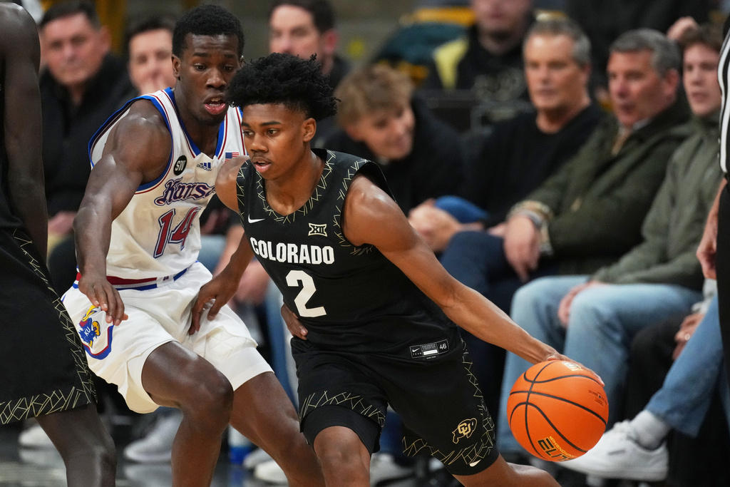 Colorado guard Isaiah Johnson, front, drives past Kansas guard Melvin Council Jr. in the first half of an NCAA college basketball game Tuesday, Jan. 20, 2026, in Boulder, Colo. (AP Photo/David Zalubowski)