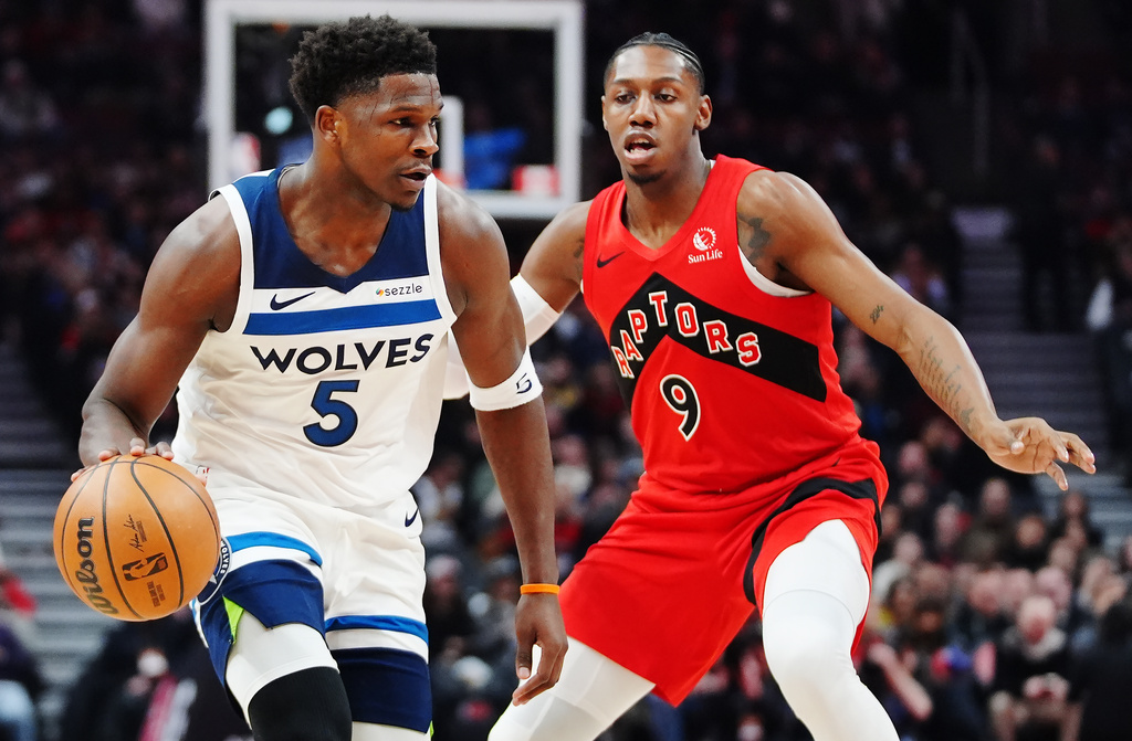 Minnesota Timberwolves' Anthony Edwards (5) protects the ball from Toronto Raptors' RJ Barrett (9) during the first half of an NBA basketball game in Toronto, Wednesday, Feb. 4, 2026. (Frank Gunn/The Canadian Press via AP)