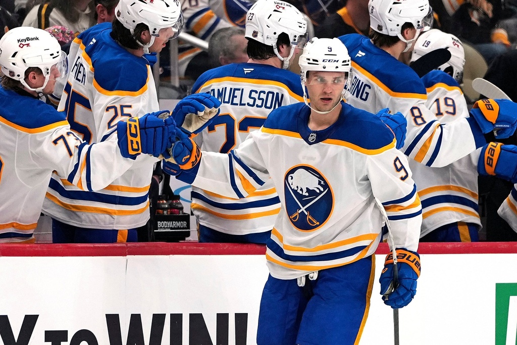 Buffalo Sabres' Josh Norris (9) returns to the bench after scoring during the second period of an NHL hockey game against the Pittsburgh Penguins in Pittsburgh, Thursday, March 5, 2026. (AP Photo/Gene J. Puskar)