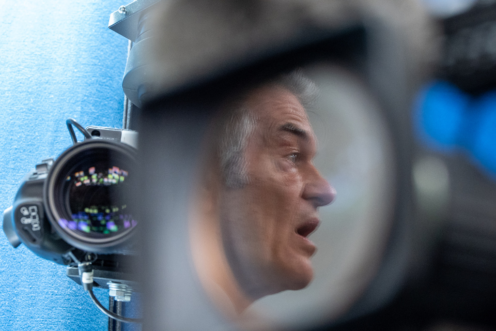 Centers for Medicare & Medicaid Services administrator Dr. Mehmet Oz is reflected in the lens of a video camera as he speaks with reporters in the James Brady Press Briefing Room at the White House, Tuesday, June 2, 2026, in Washington. (AP Photo/Alex Brandon)