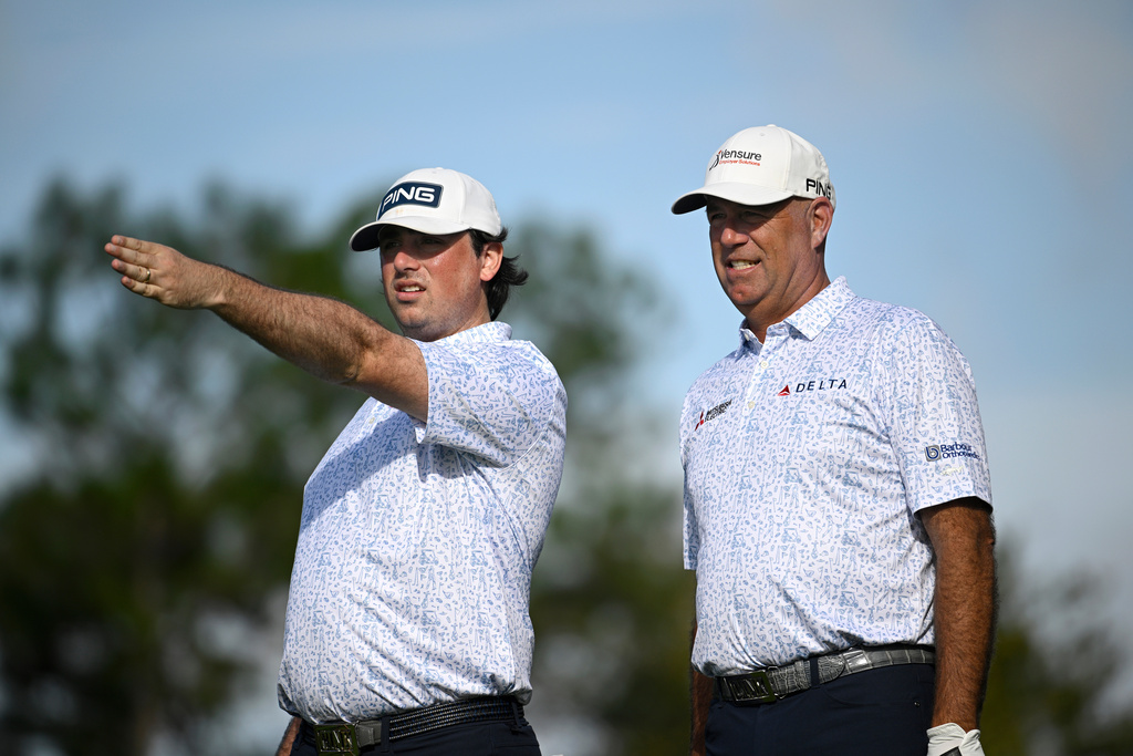 Stewart Cink, right, and his son Reagan Cink, discuss a tee shot on the second hole during the final round of the PNC Championship golf tournament, Sunday, Dec. 21, 2025, in Orlando, Fla. (AP Photo/Phelan M. Ebenhack)
