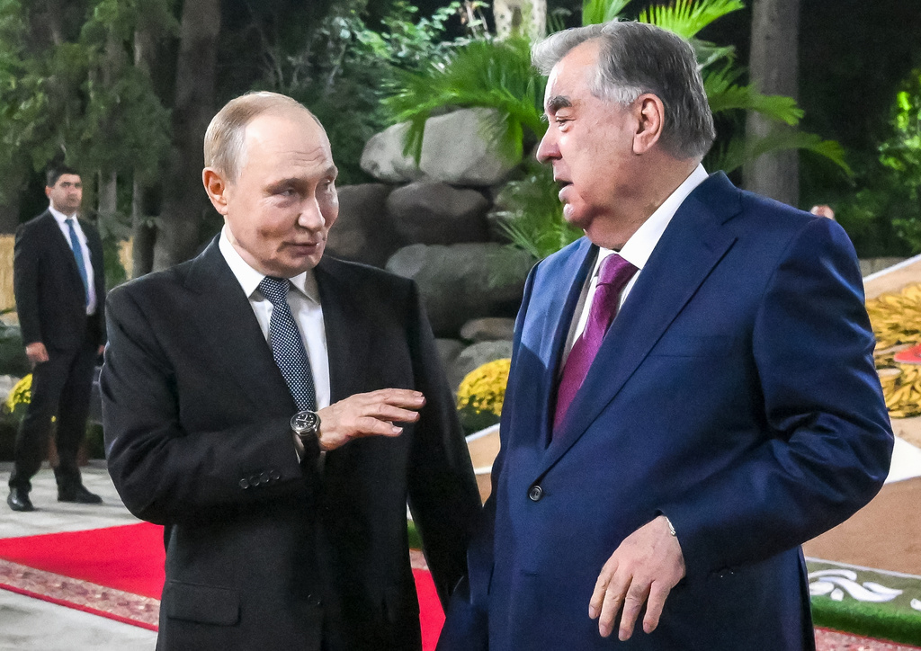Russian President Vladimir Putin, left, speaks with Tajik President Emomali Rahmon while walking at Iram botanical garden in Dushanbe, Tajikistan, Wednesday, Oct. 8, 2025. (Grigory Sysoyev, Sputnik, Kremlin Pool Photo via AP)