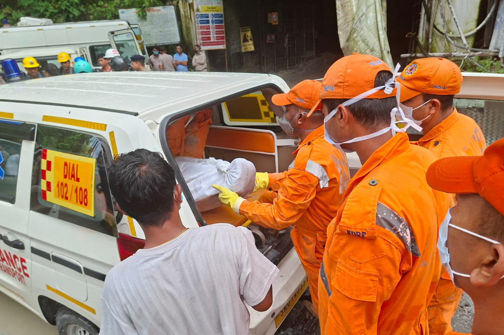 Rescue workers carry the body of a victim into an ambulance outside the entrance to an under-construction tunnel at a hydropower project in Samardung village, about 40 kilometers (25 miles) from Gangtok, India, Tuesday, July 21, 2026. (AP Photo)