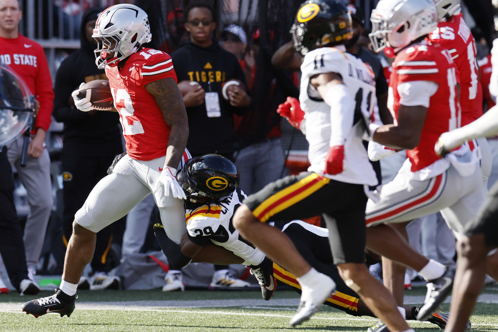 Ohio State running back CJ Donaldson, left, is forced out of bounds by Grambling State defensive back Christen Williams during the first half of an NCAA college football game, Saturday, Sept. 6, 2025, in Columbus, Ohio. (AP Photo/Jay LaPrete)