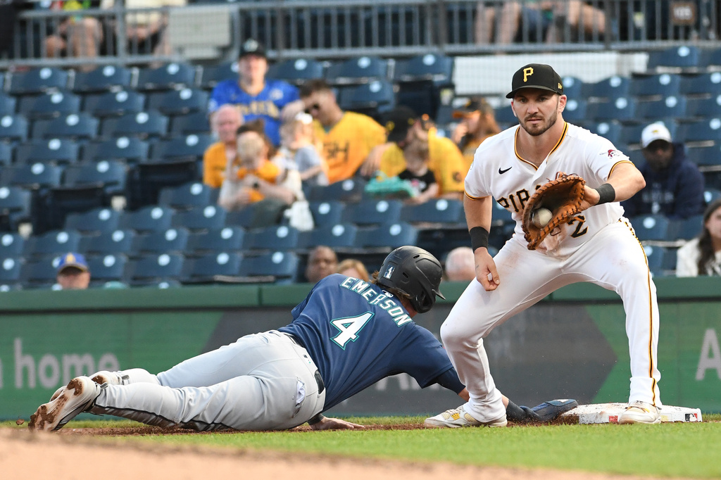 The Seattle Mariners' Colt Emerson (4) makes it back to first base safely as Pittsburgh Pirates first baseman Spencer Horwitz (2) catches theb ball on a pick off attempt in the fifth inning of a baseball game, Tuesday, June 23, 2026, in Pittsburgh. (AP Photo/Philip G. Pavely)