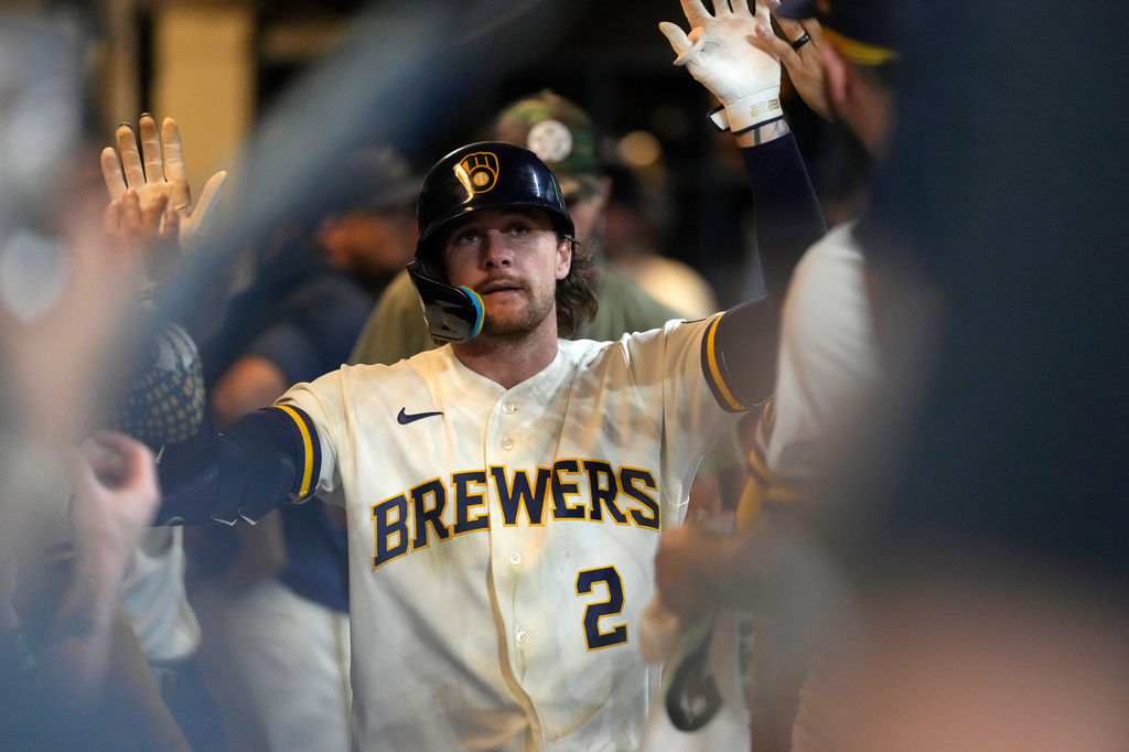 Milwaukee Brewers' Brice Turang is congratulated in the dugout after hitting a solo home run during the seventh inning of a baseball game against the Cincinnati Reds, Monday, June 29, 2026, in Milwaukee. (AP Photo/Aaron Gash)