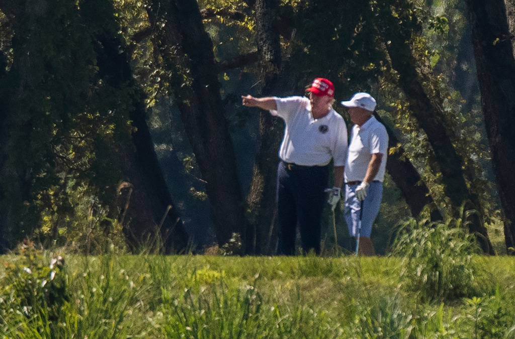 FILE - President Donald Trump and Sen. Lindsey Graham, R-S.C., right, play golf at Trump National Golf Club in Sterling, Va., as seen from the other side of the Potomac River in Darnestown, Md., July 18, 2020. (AP Photo/Manuel Balce Ceneta, File)