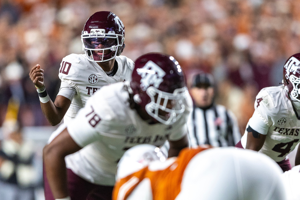 Texas A&M quarterback Marcel Reed (10) motions across the line during the first half of an NCAA college football game against Texas, Friday, Nov. 28, 2025, in Austin, Texas. (AP Photo/Stephen Spillman)
