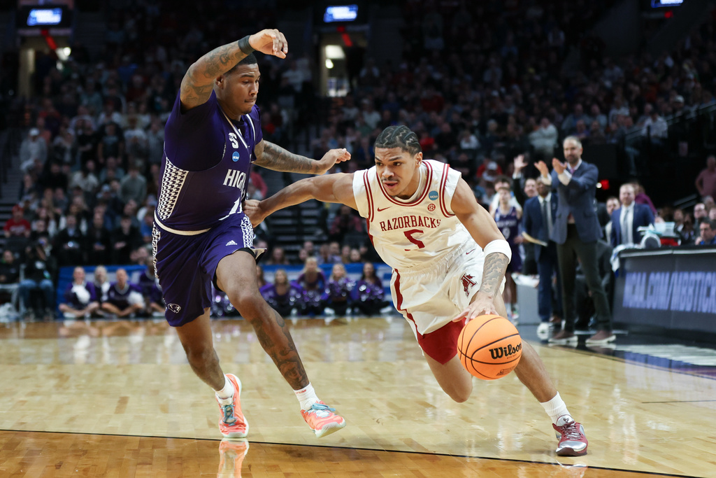 Arkansas guard Darius Acuff Jr. (5) drives to the basket past High Point forward Cam'ron Fletcher during the second half in the second round of the NCAA college basketball tournament Saturday, March 21, 2026, in Portland, Ore. (AP Photo/Amanda Loman)