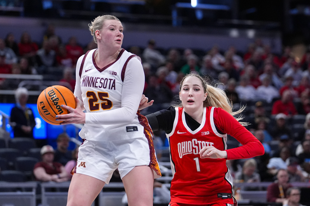 Minnesota forward Grace Grocholski (25) grabs a rebound in front of Ohio State forward Kylee Kitts (1) in the first half of an NCAA college basketball game in the quarterfinals of the Big Ten Conference tournament, Friday, March 6, 2026 in Indianapolis. (AP Photo/Michael Conroy)