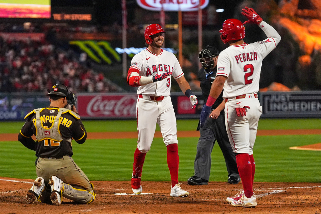 Los Angeles Angels' Josh Lowe, center, is congratulated by Oswald Peraza, right, after hitting a two-run home run as San Diego Padres catcher Luis Campusano kneels at the plate during the fifth inning of a baseball game Friday, April 17, 2026, in Anaheim, Calif. (AP Photo/Mark J. Terrill)