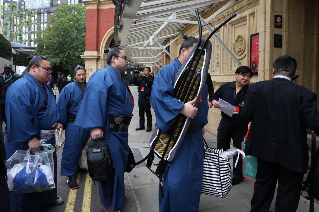 Sumo wrestlers, called rikishi, arrive for The Grand Sumo Tournament at the Royal Albert Hall in London, Wednesday, Oct. 15, 2025.(AP Photo/Frank Augstein)