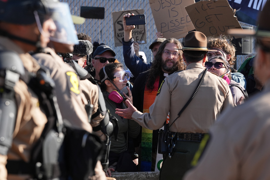 Illinois State Police and Cook County Sheriff Police guard as protesters gather outside an ICE processing facility in the Chicago suburb of Broadview, Ill., Friday, Nov. 14, 2025. (AP Photo/Nam Y. Huh)