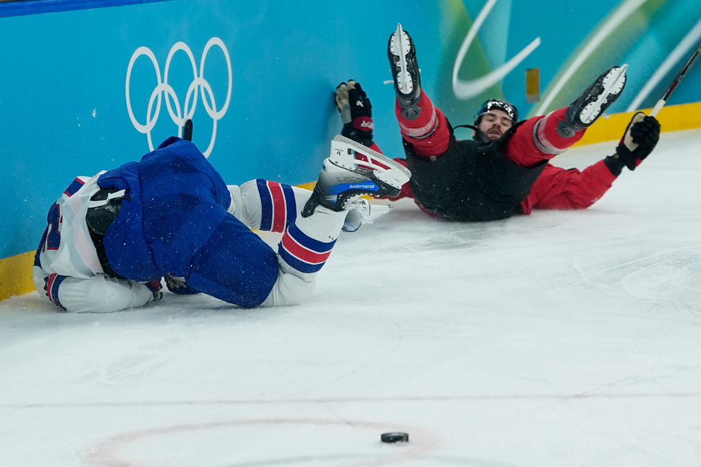 United States' Dylan Larkin (21), left, and Canada's Tom Wilson (43) collide during the first period of a men's ice hockey gold medal game between Canada and the United States at the 2026 Winter Olympics, in Milan, Italy, Sunday, Feb. 22, 2026. (AP Photo/Petr David Josek)
