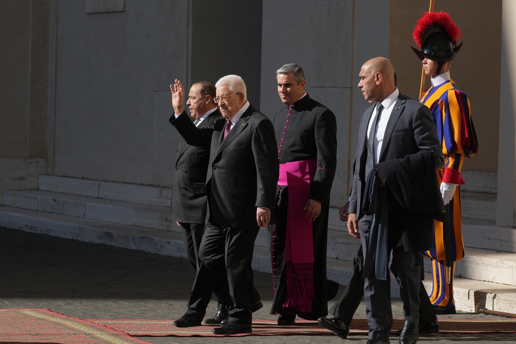 Palestinian President Mahmoud Abbas, also known as Abu Mazen,, left, waves as he leaves the St. Damasus Courtyard at the Vatican after meeting with Pope Leo XIV, Thursday, Nov. 6, 2025. (AP Photo/Andrew Medichini)