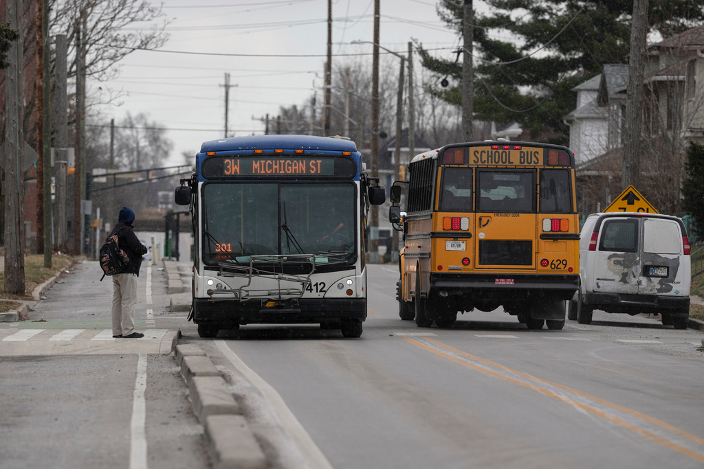 A passenger await the arrival of an IndyGo bus on the recently converted two-way portion of Michigan Street in Indianapolis, Thursday, Jan. 15, 2026. (AP Photo/Michael Conroy)